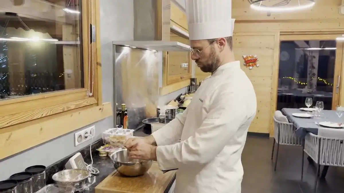 The private chef cooking in a mountain chalet kitchen
