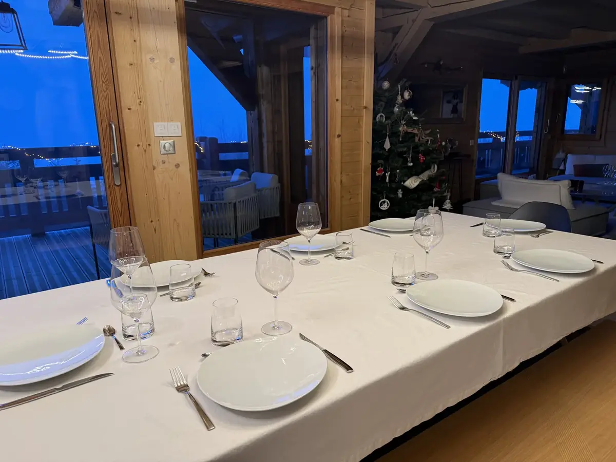 Table being set in a chalet before the guests arrive
